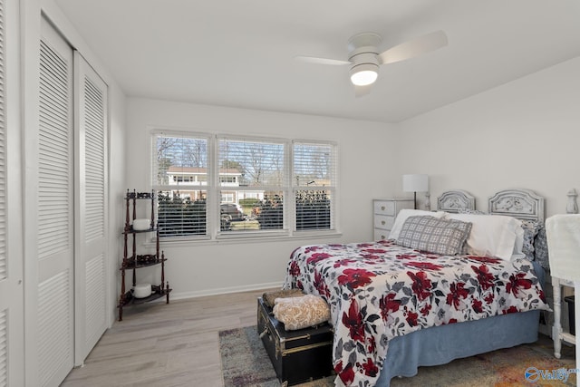 bedroom with light hardwood / wood-style floors, a closet, and ceiling fan