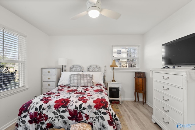 bedroom with ceiling fan and light hardwood / wood-style flooring