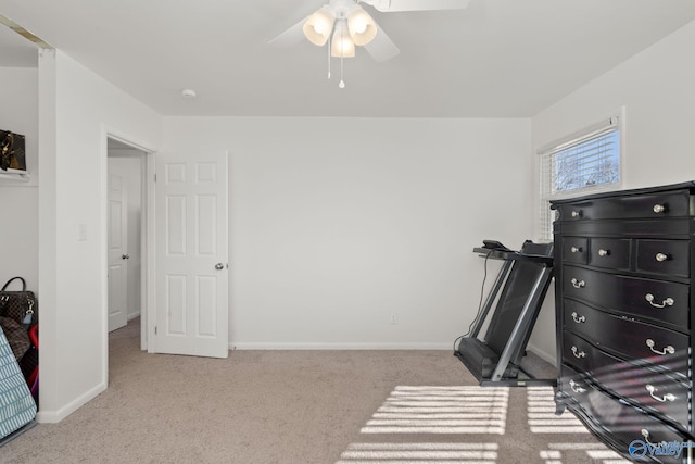 workout area featuring ceiling fan and light carpet