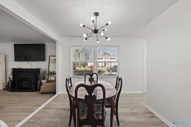 dining room with a notable chandelier and light hardwood / wood-style flooring