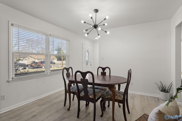 dining room featuring an inviting chandelier and light hardwood / wood-style flooring