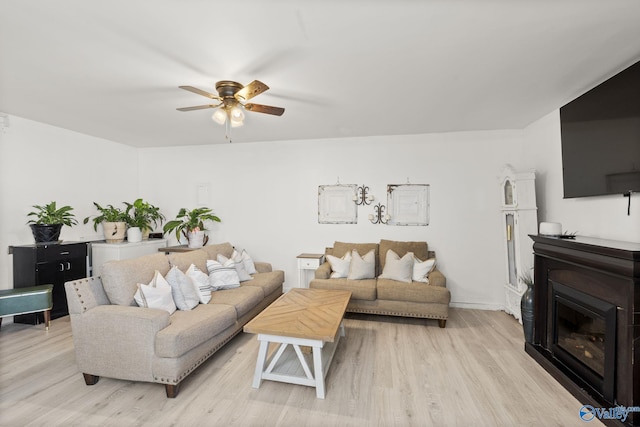 living room with ceiling fan and light hardwood / wood-style floors