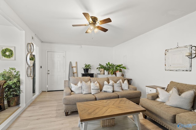 living room with ceiling fan and light hardwood / wood-style flooring