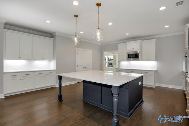 66 Natures Ridge Way, Huntsville, AL 35803 - kitchen featuring appliances with stainless steel finishes, white cabinets, light countertops, ornamental molding, and recessed lighting