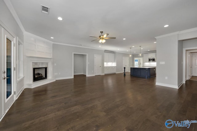 66 Natures Ridge Way, Huntsville, AL 35803 - unfurnished living room featuring a ceiling fan, recessed lighting, a premium fireplace, dark wood-style flooring, and crown molding