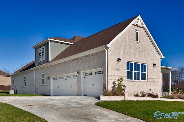 66 Natures Ridge Way, Huntsville, AL 35803 - view of side of home with brick siding, driveway, a yard, and an attached garage