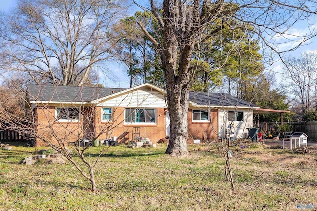 rear view of property featuring a yard