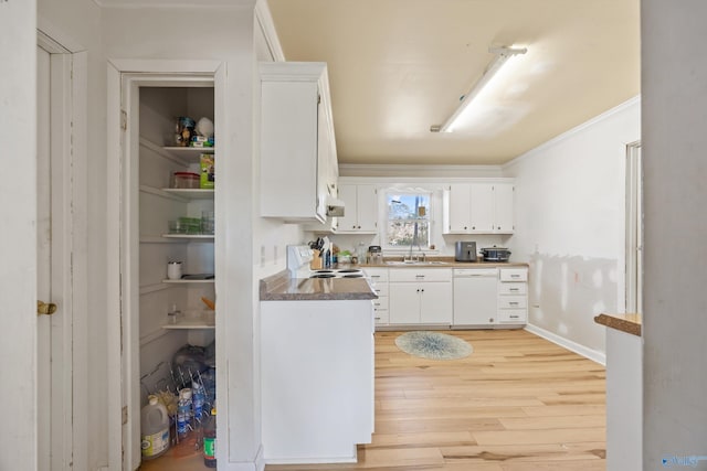 kitchen with stove, light wood-type flooring, white dishwasher, sink, and white cabinets