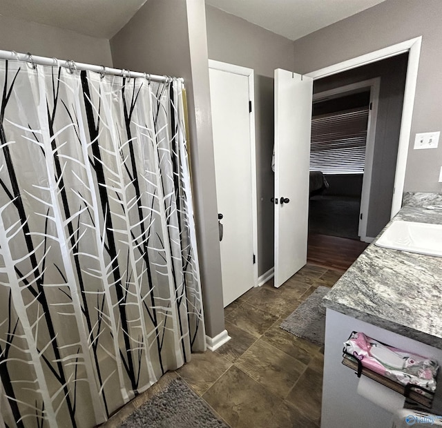 full bathroom with a shower with shower curtain and vanity