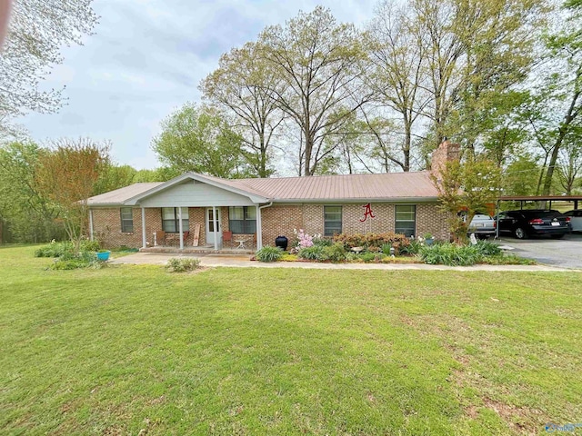 ranch-style house with a front yard, brick siding, a carport, and a chimney