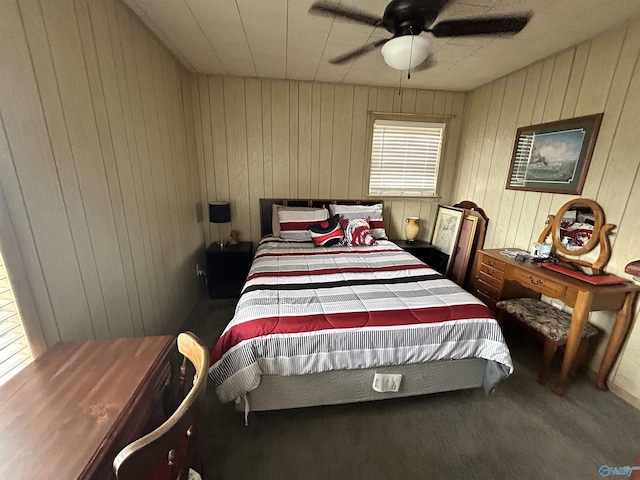 bedroom with wood walls and ceiling fan