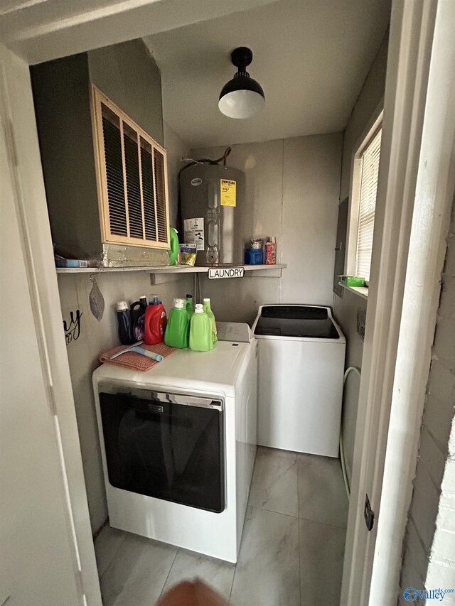 washroom with independent washer and dryer, laundry area, and electric water heater