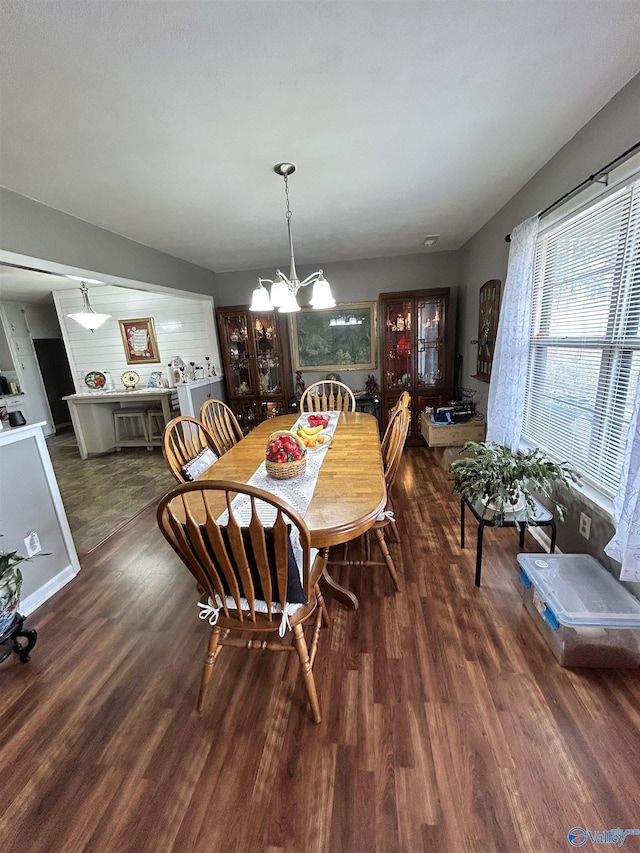 dining area with a notable chandelier and wood finished floors