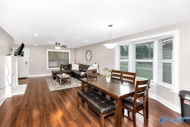 dining space featuring baseboards, wood finished floors, and recessed lighting