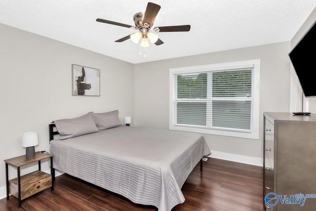 bedroom with a ceiling fan, baseboards, and dark wood-style flooring