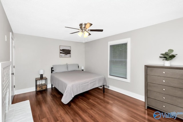 bedroom featuring ceiling fan, baseboards, and wood finished floors