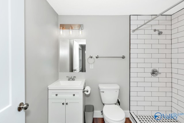 full bathroom with a shower stall, toilet, and vanity