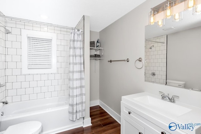 bathroom with shower / bath combo, toilet, wood finished floors, and baseboards