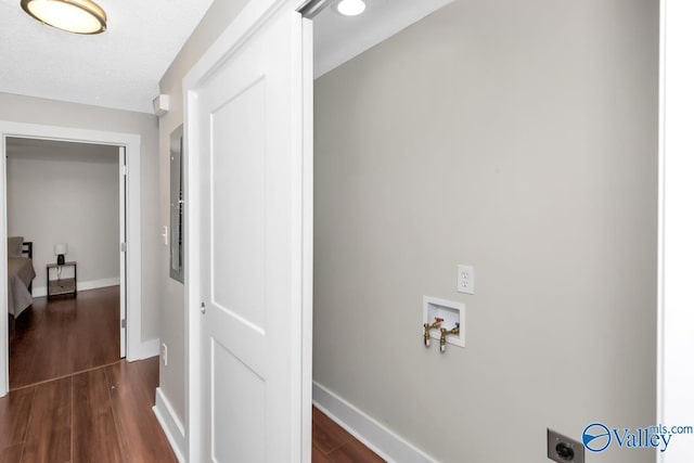 laundry room featuring wood finished floors, hookup for a washing machine, baseboards, and laundry area