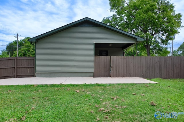 view of home's exterior featuring a lawn and fence