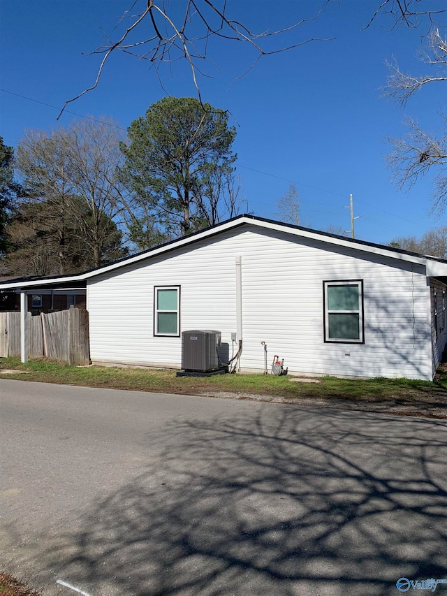 view of side of home featuring central AC