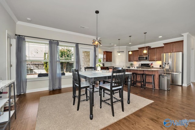 dining area with ornamental molding and dark wood-type flooring