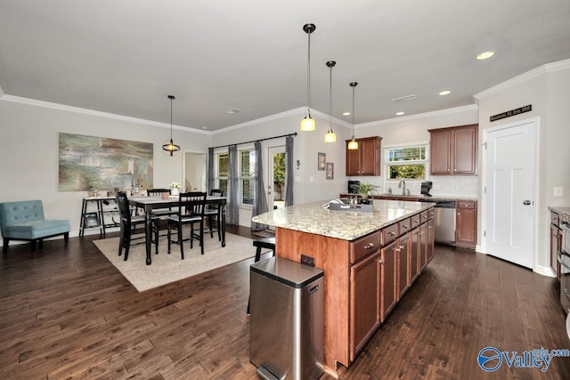 kitchen featuring decorative light fixtures, ornamental molding, dishwasher, and a kitchen island