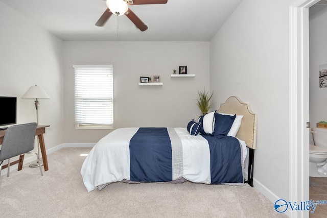 carpeted bedroom featuring ceiling fan and ensuite bath