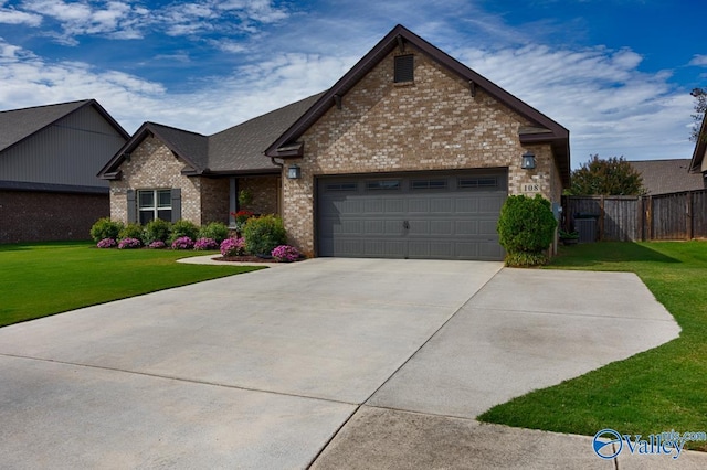 view of front of property with cooling unit, a garage, and a front yard