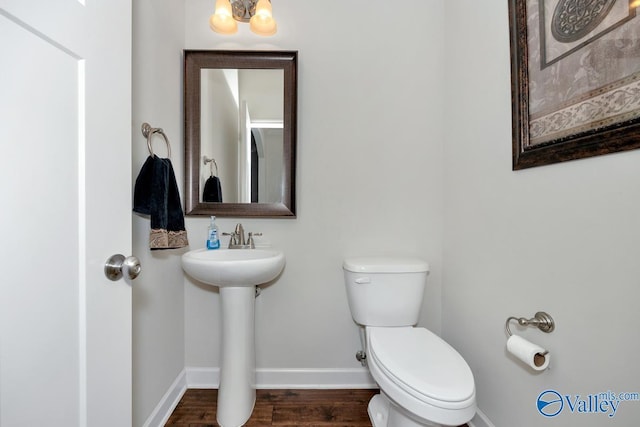 bathroom with sink, hardwood / wood-style flooring, and toilet