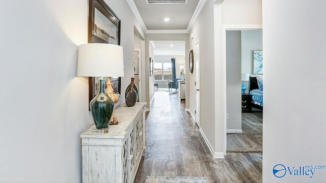 hall with light wood-type flooring and ornamental molding