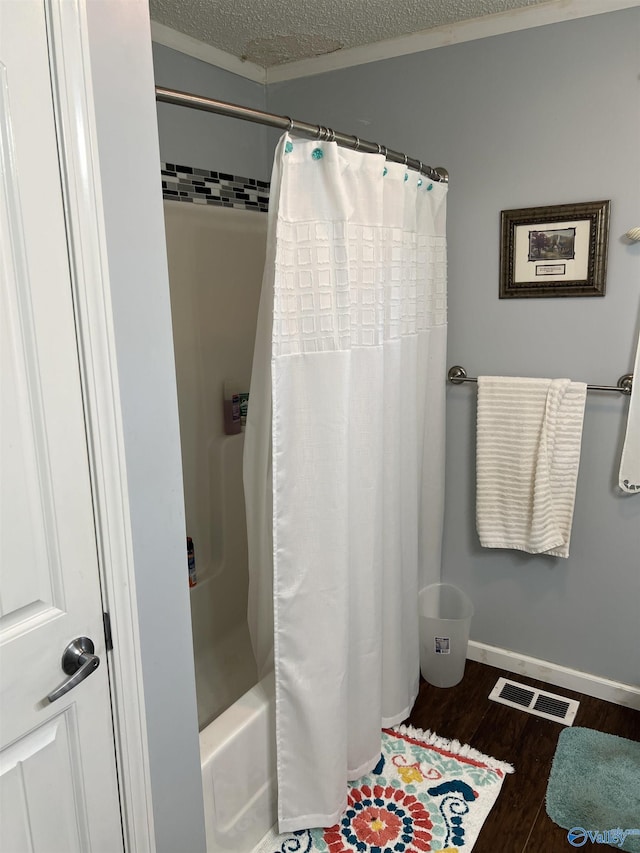 2143 Meadowood Dr, Southside, AL 35907 - bathroom with wood finished floors, a textured ceiling, shower / bathtub combination with curtain, and baseboards