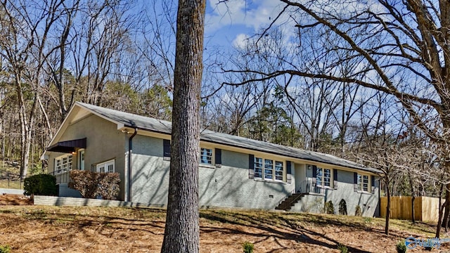 ranch-style house with crawl space, brick siding, and fence