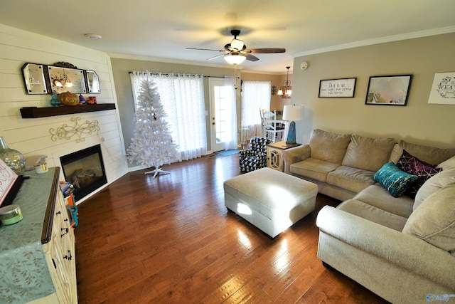 living room with ceiling fan, a fireplace, dark wood-type flooring, and ornamental molding