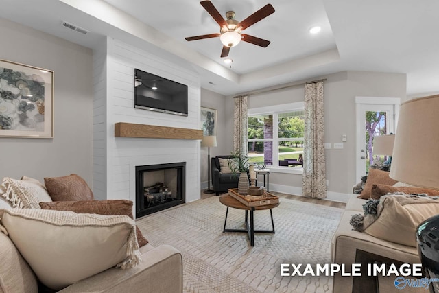 303 Keller Dr, Hazel Green, AL 35750 - living area featuring a tray ceiling, a ceiling fan, a fireplace, wood finished floors, and recessed lighting