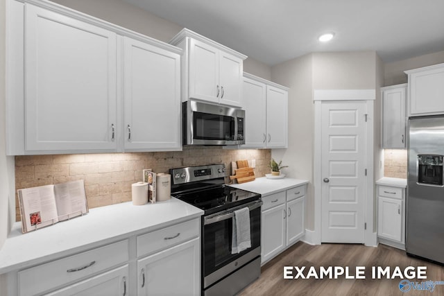 303 Keller Dr, Hazel Green, AL 35750 - kitchen with stainless steel appliances, white cabinets, wood finished floors, light countertops, and recessed lighting