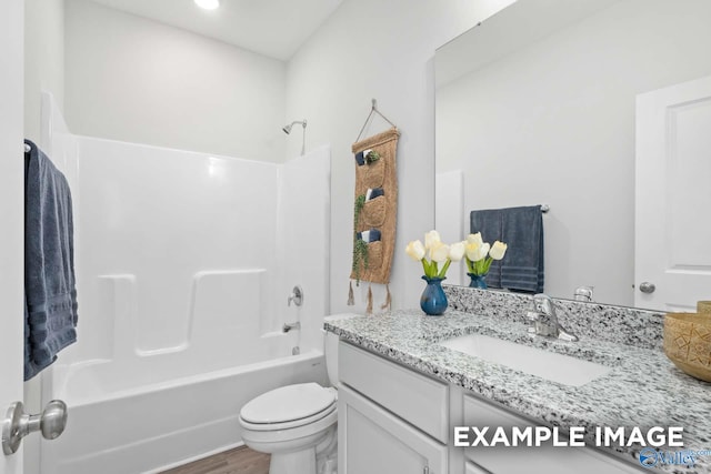 full bathroom featuring vanity, toilet, wood-type flooring, and shower / washtub combination