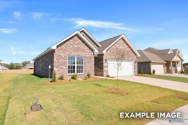 view of front of house featuring a garage and a front lawn