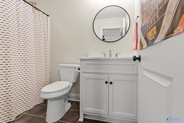 bathroom featuring tile patterned flooring, a shower with curtain, vanity, and toilet