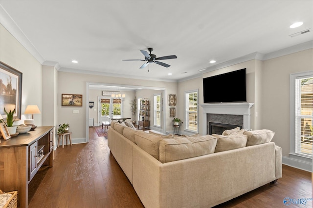 living room featuring ceiling fan, dark hardwood / wood-style flooring, a healthy amount of sunlight, and a brick fireplace