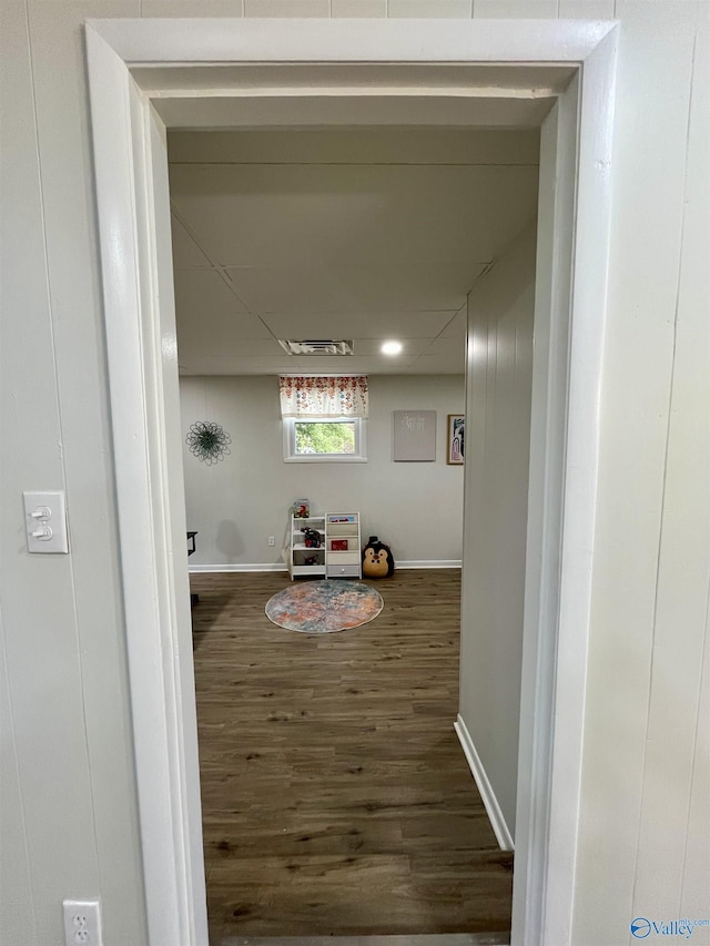 hall featuring baseboards and dark wood-style floors