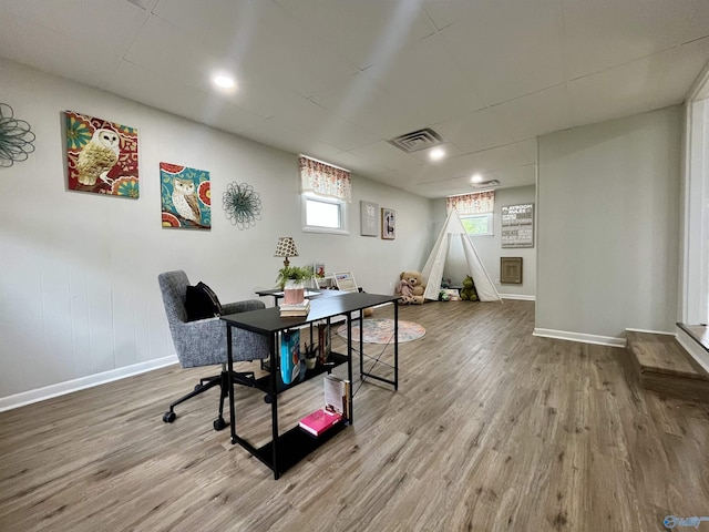 home office with visible vents, baseboards, and wood finished floors