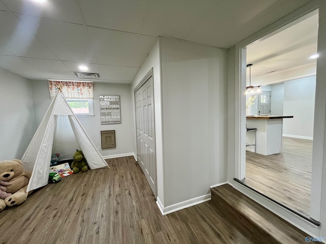 game room with wood finished floors, baseboards, and visible vents