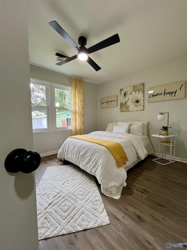 bedroom featuring wood finished floors, ceiling fan, and baseboards