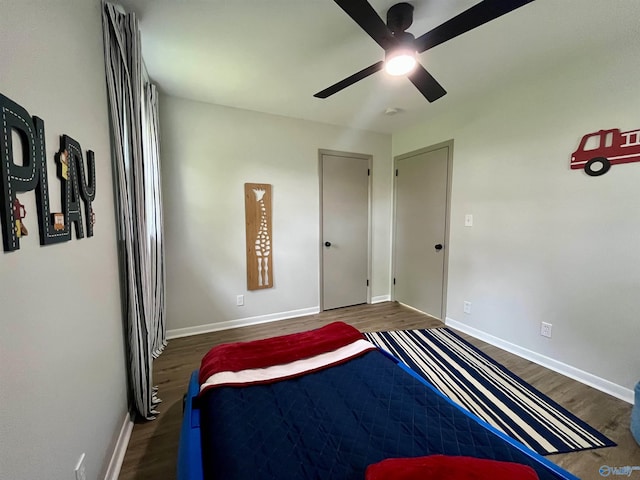 bedroom with baseboards, ceiling fan, and wood finished floors