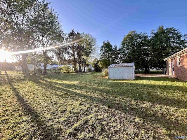 view of yard with a shed and an outbuilding