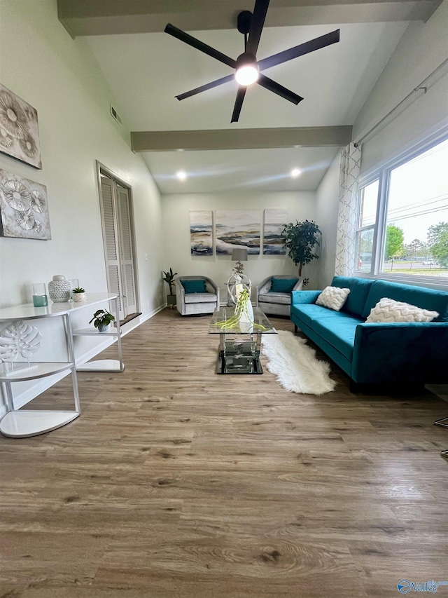 living room with visible vents, vaulted ceiling with beams, a ceiling fan, and wood finished floors