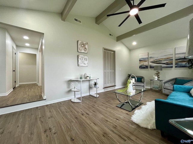 living area with visible vents, ceiling fan, vaulted ceiling with beams, and wood finished floors