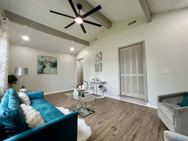 living room with baseboards, lofted ceiling with beams, visible vents, ceiling fan, and wood finished floors