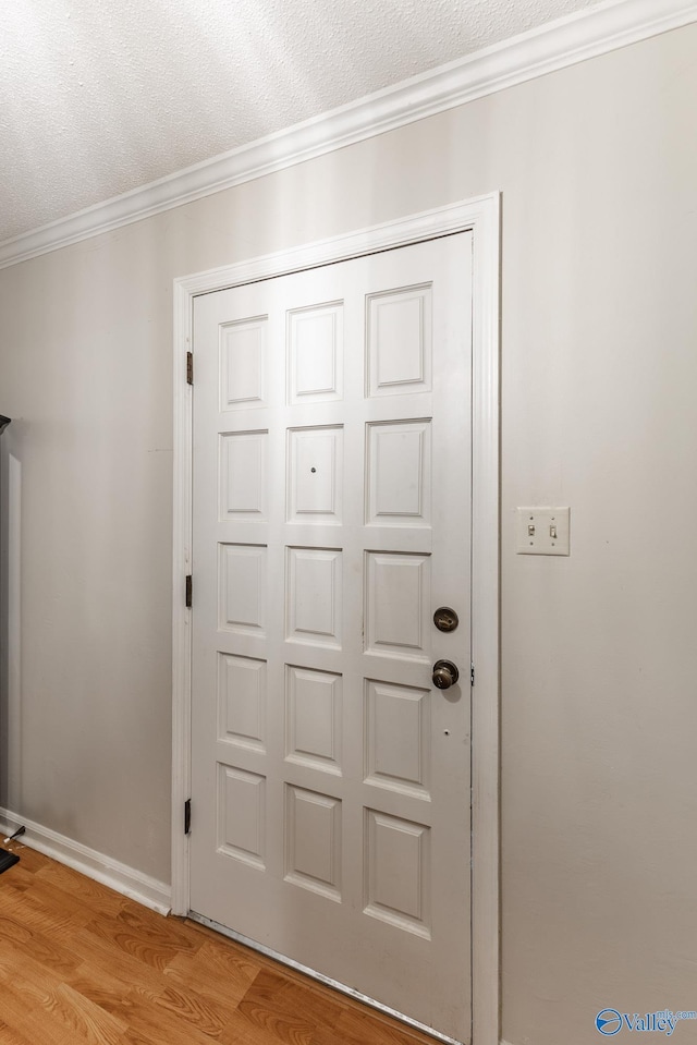 43 Terry Ln, Trinity, AL 35673 - entryway with ornamental molding, light wood finished floors, a textured ceiling, and baseboards